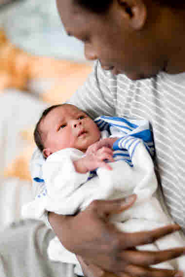 Pappa håller nyfödd baby i famnen BB Karolinska (2016).