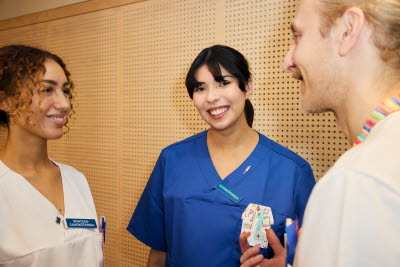 En manlig och en kvinnlig sjuksköterska samtalar med en röntgensjuksköterska